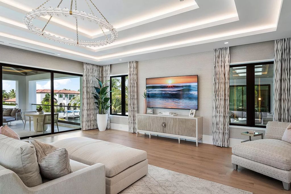 Indulge in the epitome of waterfront luxury at this 10,784-square-foot estate in Royal Palm Yacht & Country Club. Crafted by Wietsma Lippolis Construction, this masterpiece boasts six bedroom suites, expansive living areas curated by Artisan Interiors, and cutting-edge Crestron home technology.