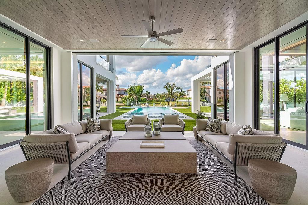 Indulge in the epitome of waterfront luxury at this 10,784-square-foot estate in Royal Palm Yacht & Country Club. Crafted by Wietsma Lippolis Construction, this masterpiece boasts six bedroom suites, expansive living areas curated by Artisan Interiors, and cutting-edge Crestron home technology.