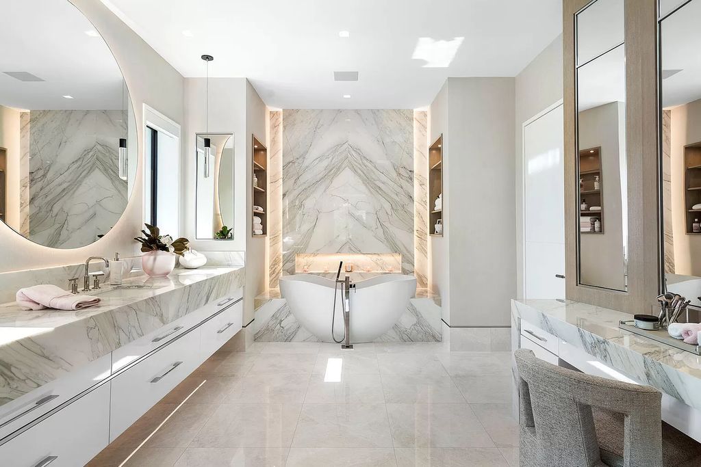 Indulge in the epitome of waterfront luxury at this 10,784-square-foot estate in Royal Palm Yacht & Country Club. Crafted by Wietsma Lippolis Construction, this masterpiece boasts six bedroom suites, expansive living areas curated by Artisan Interiors, and cutting-edge Crestron home technology.