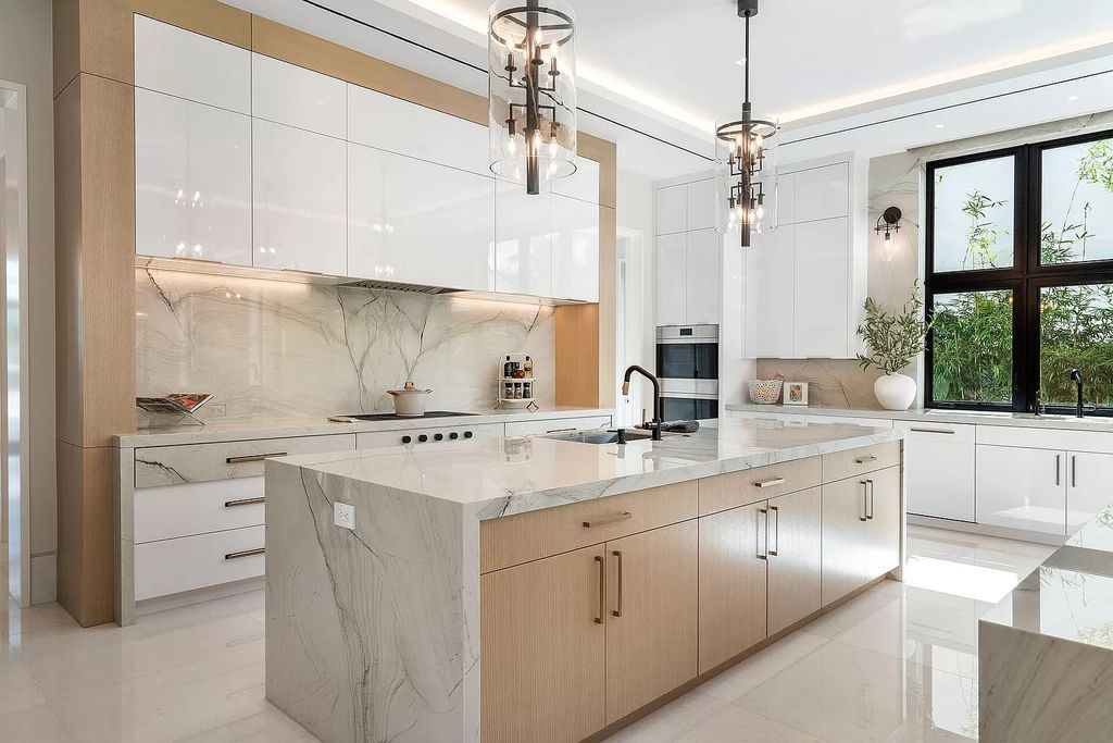 Indulge in the epitome of waterfront luxury at this 10,784-square-foot estate in Royal Palm Yacht & Country Club. Crafted by Wietsma Lippolis Construction, this masterpiece boasts six bedroom suites, expansive living areas curated by Artisan Interiors, and cutting-edge Crestron home technology.