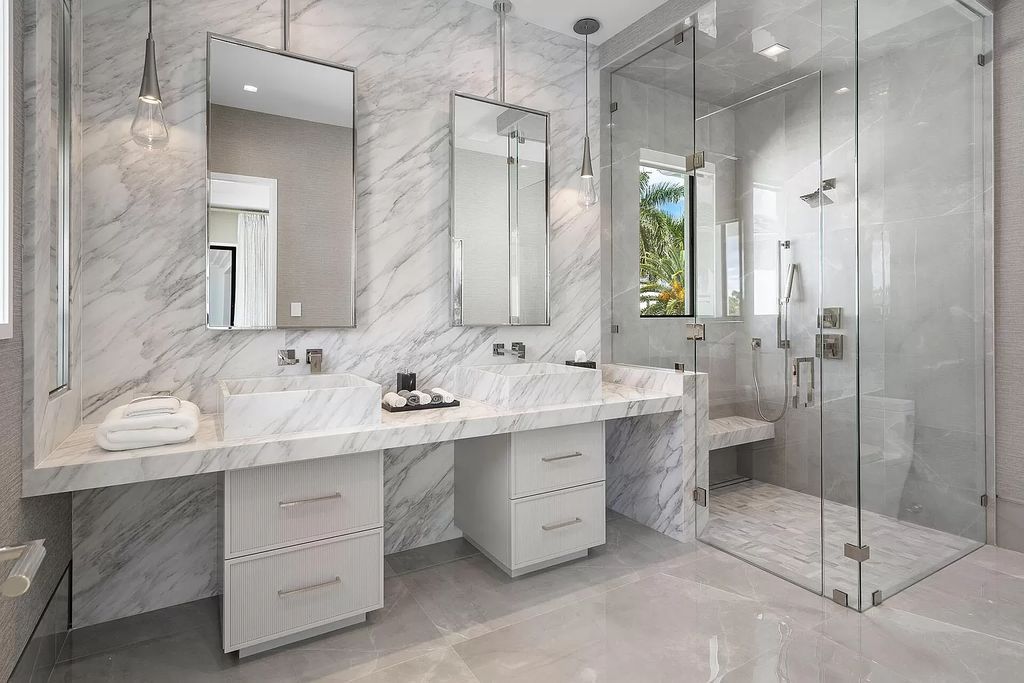 Indulge in the epitome of waterfront luxury at this 10,784-square-foot estate in Royal Palm Yacht & Country Club. Crafted by Wietsma Lippolis Construction, this masterpiece boasts six bedroom suites, expansive living areas curated by Artisan Interiors, and cutting-edge Crestron home technology.