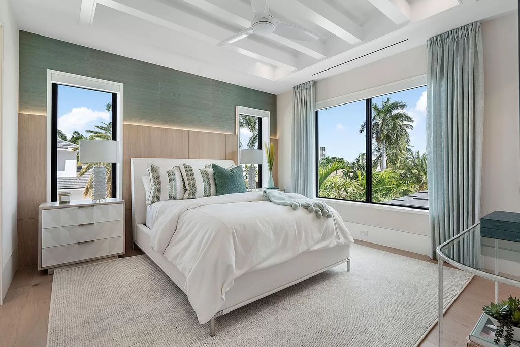 Indulge in the epitome of waterfront luxury at this 10,784-square-foot estate in Royal Palm Yacht & Country Club. Crafted by Wietsma Lippolis Construction, this masterpiece boasts six bedroom suites, expansive living areas curated by Artisan Interiors, and cutting-edge Crestron home technology.