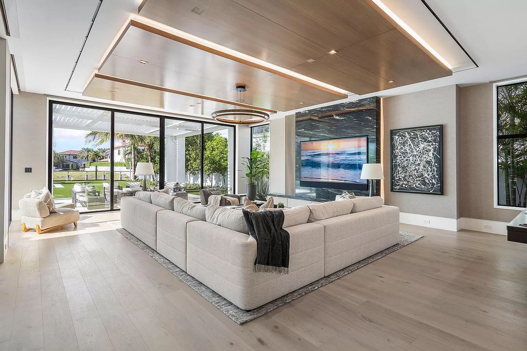 Indulge in the epitome of waterfront luxury at this 10,784-square-foot estate in Royal Palm Yacht & Country Club. Crafted by Wietsma Lippolis Construction, this masterpiece boasts six bedroom suites, expansive living areas curated by Artisan Interiors, and cutting-edge Crestron home technology.