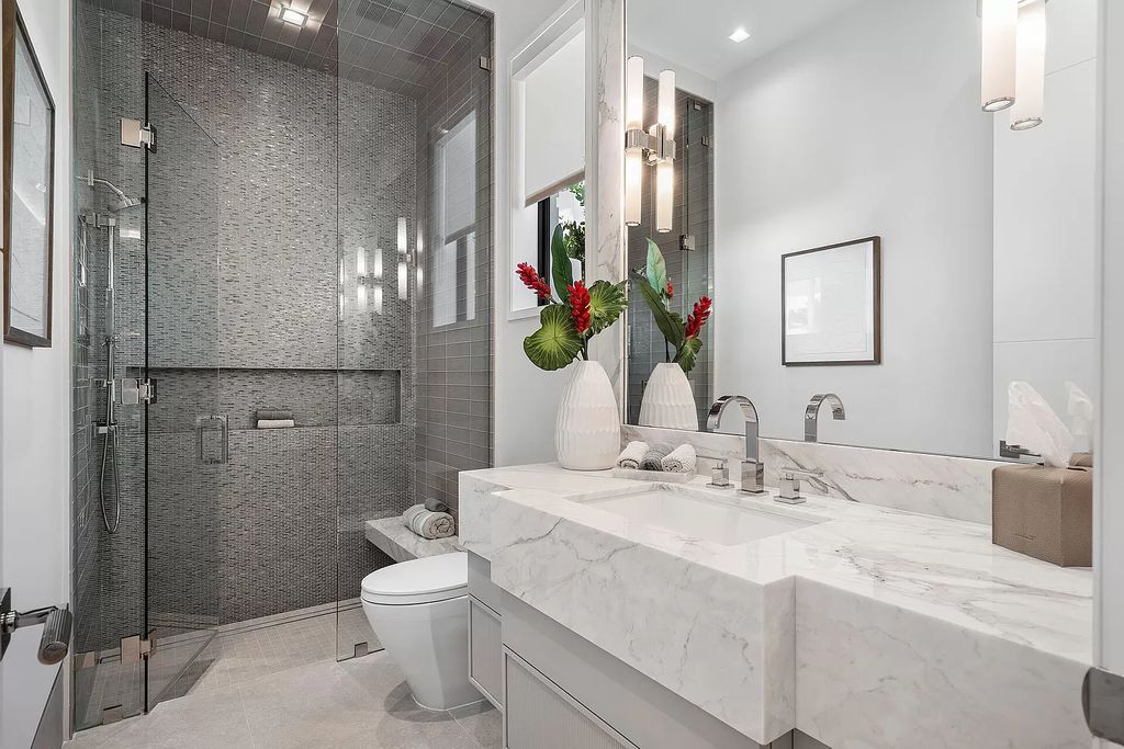 Indulge in the epitome of waterfront luxury at this 10,784-square-foot estate in Royal Palm Yacht & Country Club. Crafted by Wietsma Lippolis Construction, this masterpiece boasts six bedroom suites, expansive living areas curated by Artisan Interiors, and cutting-edge Crestron home technology.