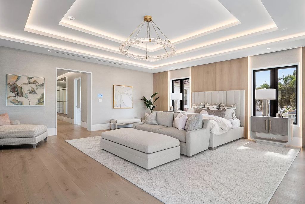 Indulge in the epitome of waterfront luxury at this 10,784-square-foot estate in Royal Palm Yacht & Country Club. Crafted by Wietsma Lippolis Construction, this masterpiece boasts six bedroom suites, expansive living areas curated by Artisan Interiors, and cutting-edge Crestron home technology.