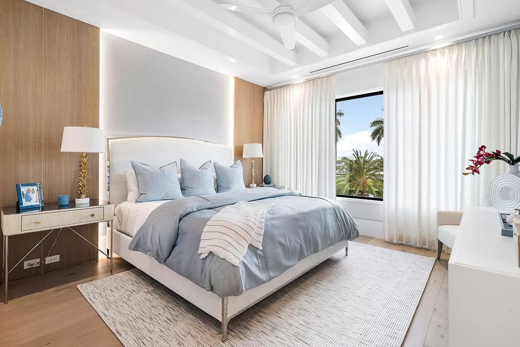 Indulge in the epitome of waterfront luxury at this 10,784-square-foot estate in Royal Palm Yacht & Country Club. Crafted by Wietsma Lippolis Construction, this masterpiece boasts six bedroom suites, expansive living areas curated by Artisan Interiors, and cutting-edge Crestron home technology.