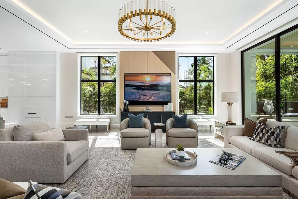 Indulge in the epitome of waterfront luxury at this 10,784-square-foot estate in Royal Palm Yacht & Country Club. Crafted by Wietsma Lippolis Construction, this masterpiece boasts six bedroom suites, expansive living areas curated by Artisan Interiors, and cutting-edge Crestron home technology.