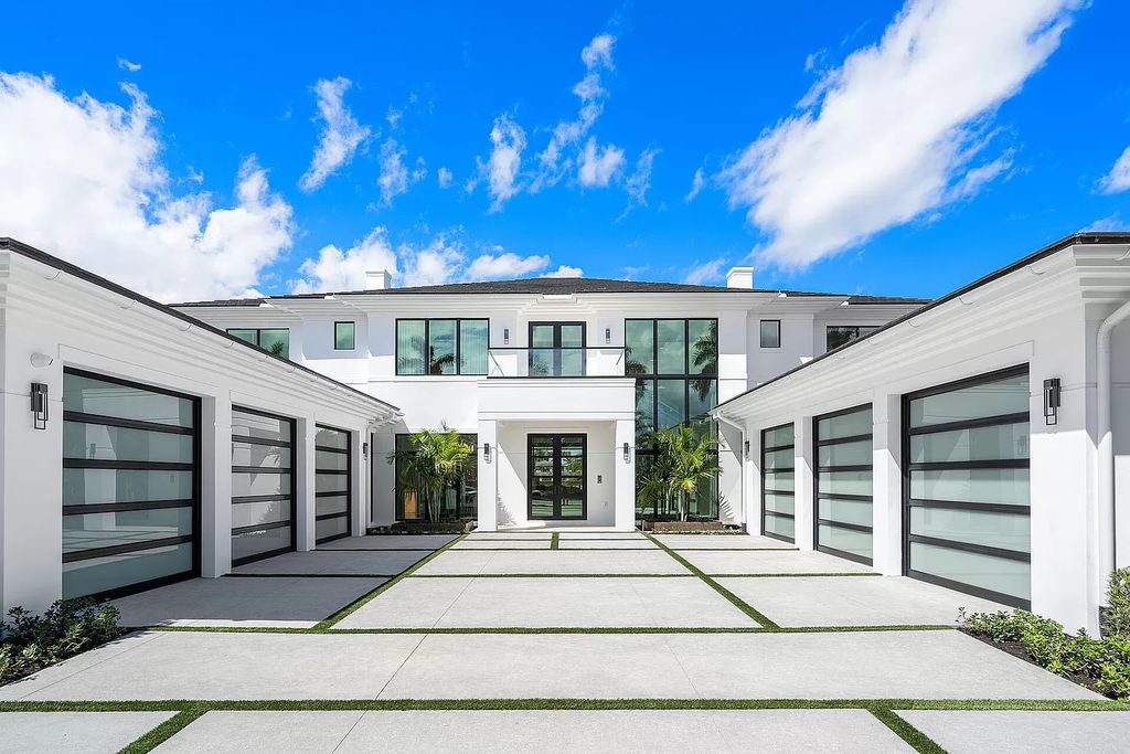 Indulge in the epitome of waterfront luxury at this 10,784-square-foot estate in Royal Palm Yacht & Country Club. Crafted by Wietsma Lippolis Construction, this masterpiece boasts six bedroom suites, expansive living areas curated by Artisan Interiors, and cutting-edge Crestron home technology.
