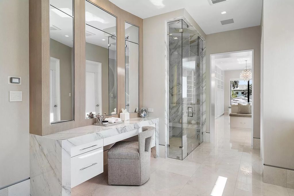 Indulge in the epitome of waterfront luxury at this 10,784-square-foot estate in Royal Palm Yacht & Country Club. Crafted by Wietsma Lippolis Construction, this masterpiece boasts six bedroom suites, expansive living areas curated by Artisan Interiors, and cutting-edge Crestron home technology.
