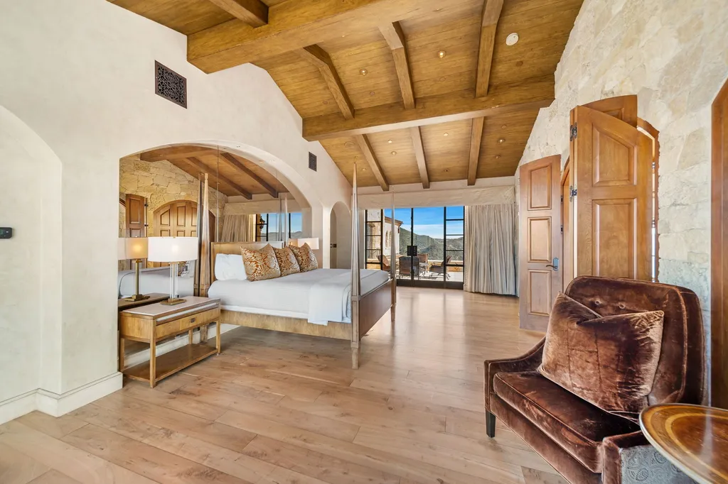 340 North Kanan Dume Road Home in Malibu, California. Perched atop a Malibu Canyon peak, the majestic Malibu Rocky Oaks is a stone-clad Tuscan villa offering unrivaled luxury and panoramic views. This 9,000-square-foot estate boasts 37 picturesque acres, a renowned vineyard, and endless world-class amenities. With a private helipad and infinity pool, this masterpiece redefines the essence of luxury living in the Malibu hills.