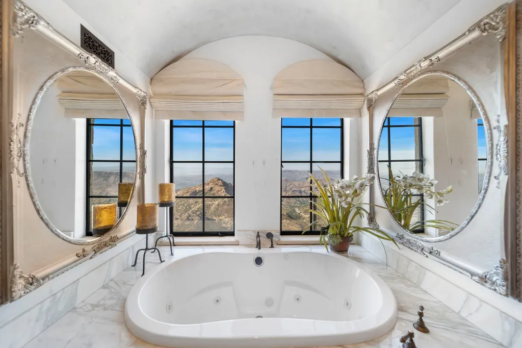 340 North Kanan Dume Road Home in Malibu, California. Perched atop a Malibu Canyon peak, the majestic Malibu Rocky Oaks is a stone-clad Tuscan villa offering unrivaled luxury and panoramic views. This 9,000-square-foot estate boasts 37 picturesque acres, a renowned vineyard, and endless world-class amenities. With a private helipad and infinity pool, this masterpiece redefines the essence of luxury living in the Malibu hills.