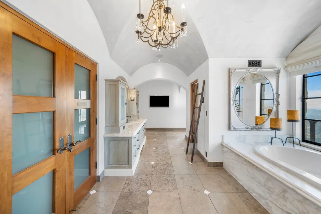 340 North Kanan Dume Road Home in Malibu, California. Perched atop a Malibu Canyon peak, the majestic Malibu Rocky Oaks is a stone-clad Tuscan villa offering unrivaled luxury and panoramic views. This 9,000-square-foot estate boasts 37 picturesque acres, a renowned vineyard, and endless world-class amenities. With a private helipad and infinity pool, this masterpiece redefines the essence of luxury living in the Malibu hills.
