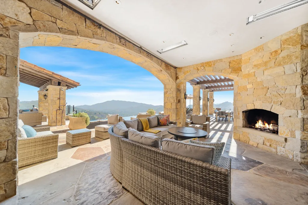 340 North Kanan Dume Road Home in Malibu, California. Perched atop a Malibu Canyon peak, the majestic Malibu Rocky Oaks is a stone-clad Tuscan villa offering unrivaled luxury and panoramic views. This 9,000-square-foot estate boasts 37 picturesque acres, a renowned vineyard, and endless world-class amenities. With a private helipad and infinity pool, this masterpiece redefines the essence of luxury living in the Malibu hills.
