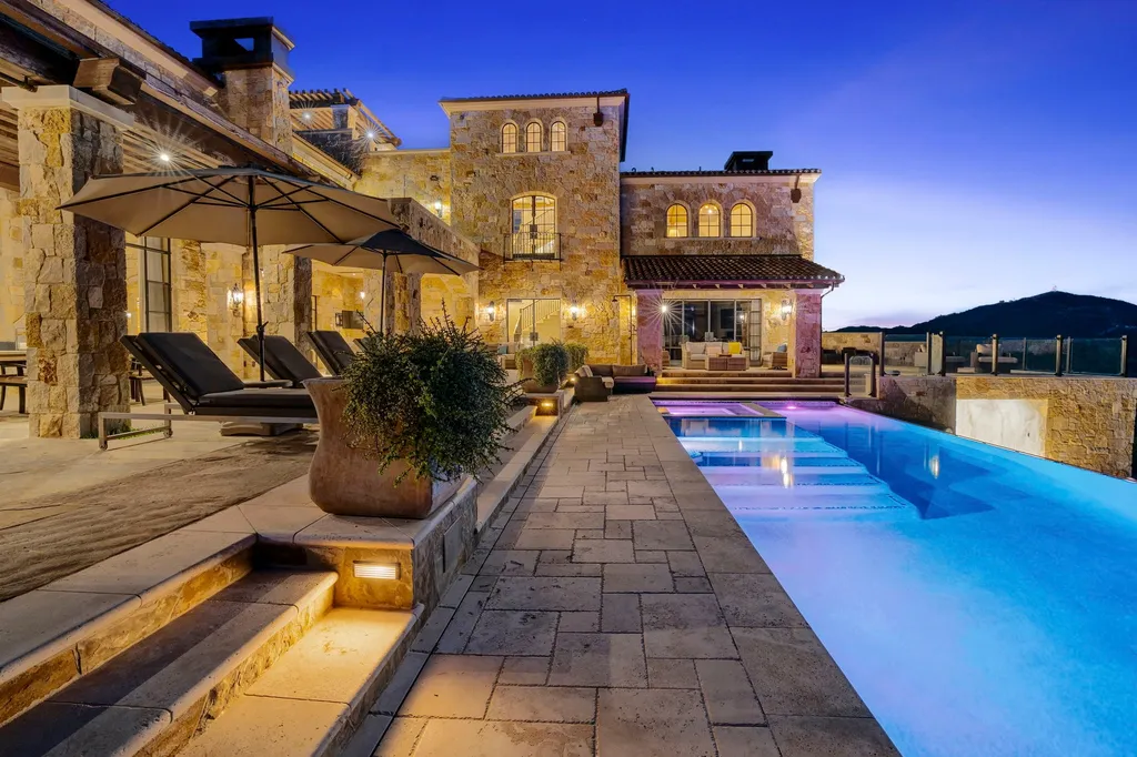 340 North Kanan Dume Road Home in Malibu, California. Perched atop a Malibu Canyon peak, the majestic Malibu Rocky Oaks is a stone-clad Tuscan villa offering unrivaled luxury and panoramic views. This 9,000-square-foot estate boasts 37 picturesque acres, a renowned vineyard, and endless world-class amenities. With a private helipad and infinity pool, this masterpiece redefines the essence of luxury living in the Malibu hills.
