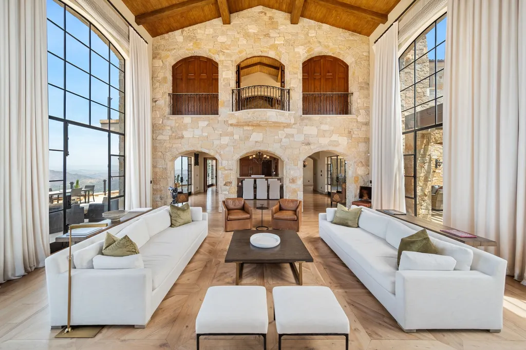 340 North Kanan Dume Road Home in Malibu, California. Perched atop a Malibu Canyon peak, the majestic Malibu Rocky Oaks is a stone-clad Tuscan villa offering unrivaled luxury and panoramic views. This 9,000-square-foot estate boasts 37 picturesque acres, a renowned vineyard, and endless world-class amenities. With a private helipad and infinity pool, this masterpiece redefines the essence of luxury living in the Malibu hills.