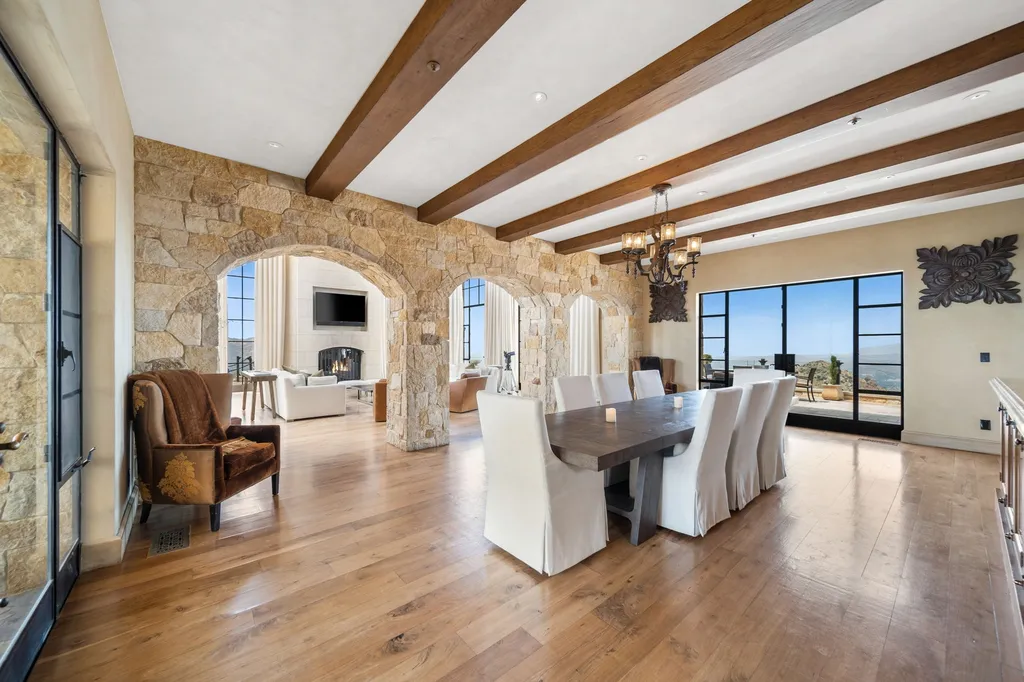 340 North Kanan Dume Road Home in Malibu, California. Perched atop a Malibu Canyon peak, the majestic Malibu Rocky Oaks is a stone-clad Tuscan villa offering unrivaled luxury and panoramic views. This 9,000-square-foot estate boasts 37 picturesque acres, a renowned vineyard, and endless world-class amenities. With a private helipad and infinity pool, this masterpiece redefines the essence of luxury living in the Malibu hills.