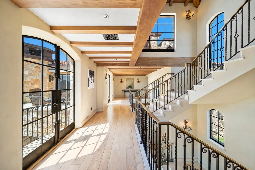 340 North Kanan Dume Road Home in Malibu, California. Perched atop a Malibu Canyon peak, the majestic Malibu Rocky Oaks is a stone-clad Tuscan villa offering unrivaled luxury and panoramic views. This 9,000-square-foot estate boasts 37 picturesque acres, a renowned vineyard, and endless world-class amenities. With a private helipad and infinity pool, this masterpiece redefines the essence of luxury living in the Malibu hills.
