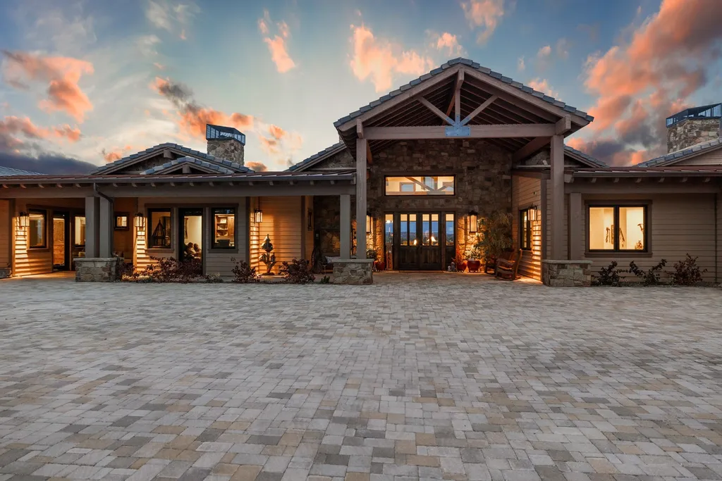 4971 West Three Forks Road Home in Prescott, Arizona. Explore the epitome of luxury living in this privately gated ranch compound with unobstructed views. This 4-bedroom, 5,555 sq.ft home features a 7-car garage, attached guest quarters, private pool with cabana, wet bar, and a 20 ft indoor-outdoor panoramic glass wall door.