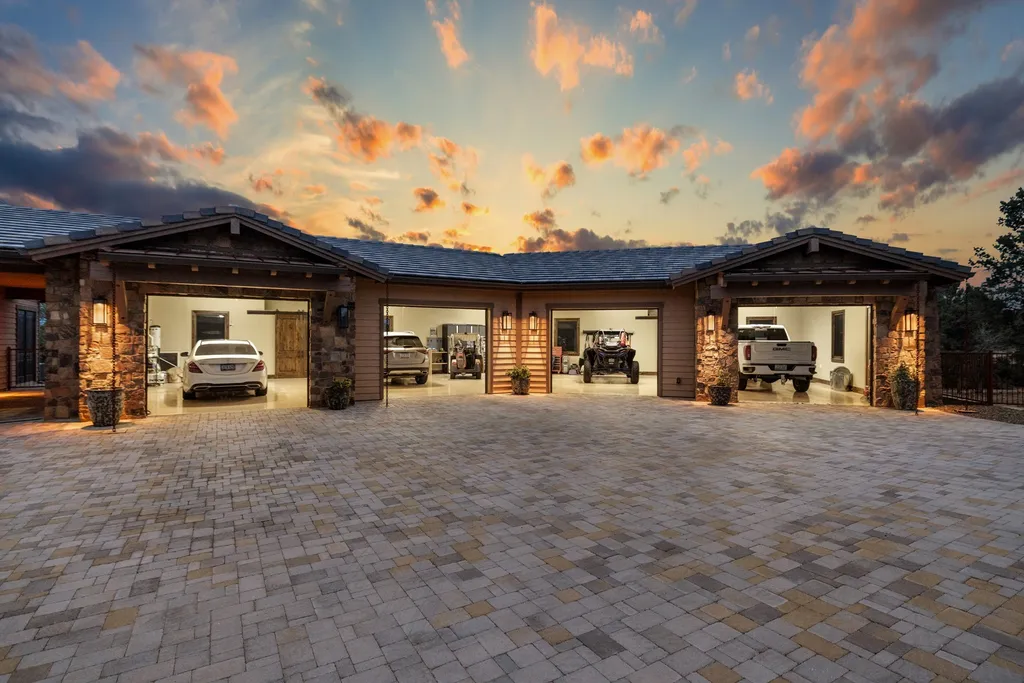 4971 West Three Forks Road Home in Prescott, Arizona. Explore the epitome of luxury living in this privately gated ranch compound with unobstructed views. This 4-bedroom, 5,555 sq.ft home features a 7-car garage, attached guest quarters, private pool with cabana, wet bar, and a 20 ft indoor-outdoor panoramic glass wall door.
