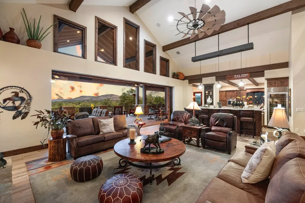 4971 West Three Forks Road Home in Prescott, Arizona. Explore the epitome of luxury living in this privately gated ranch compound with unobstructed views. This 4-bedroom, 5,555 sq.ft home features a 7-car garage, attached guest quarters, private pool with cabana, wet bar, and a 20 ft indoor-outdoor panoramic glass wall door.