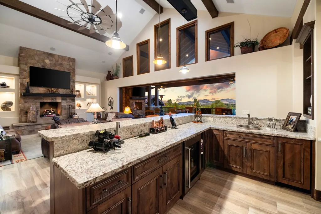 4971 West Three Forks Road Home in Prescott, Arizona. Explore the epitome of luxury living in this privately gated ranch compound with unobstructed views. This 4-bedroom, 5,555 sq.ft home features a 7-car garage, attached guest quarters, private pool with cabana, wet bar, and a 20 ft indoor-outdoor panoramic glass wall door.
