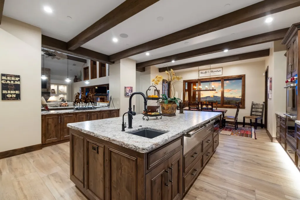 4971 West Three Forks Road Home in Prescott, Arizona. Explore the epitome of luxury living in this privately gated ranch compound with unobstructed views. This 4-bedroom, 5,555 sq.ft home features a 7-car garage, attached guest quarters, private pool with cabana, wet bar, and a 20 ft indoor-outdoor panoramic glass wall door.