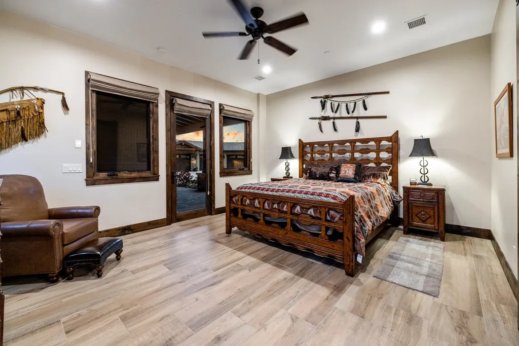 4971 West Three Forks Road Home in Prescott, Arizona. Explore the epitome of luxury living in this privately gated ranch compound with unobstructed views. This 4-bedroom, 5,555 sq.ft home features a 7-car garage, attached guest quarters, private pool with cabana, wet bar, and a 20 ft indoor-outdoor panoramic glass wall door.