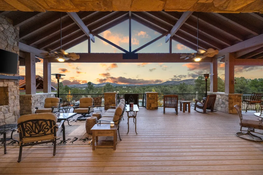 4971 West Three Forks Road Home in Prescott, Arizona. Explore the epitome of luxury living in this privately gated ranch compound with unobstructed views. This 4-bedroom, 5,555 sq.ft home features a 7-car garage, attached guest quarters, private pool with cabana, wet bar, and a 20 ft indoor-outdoor panoramic glass wall door.