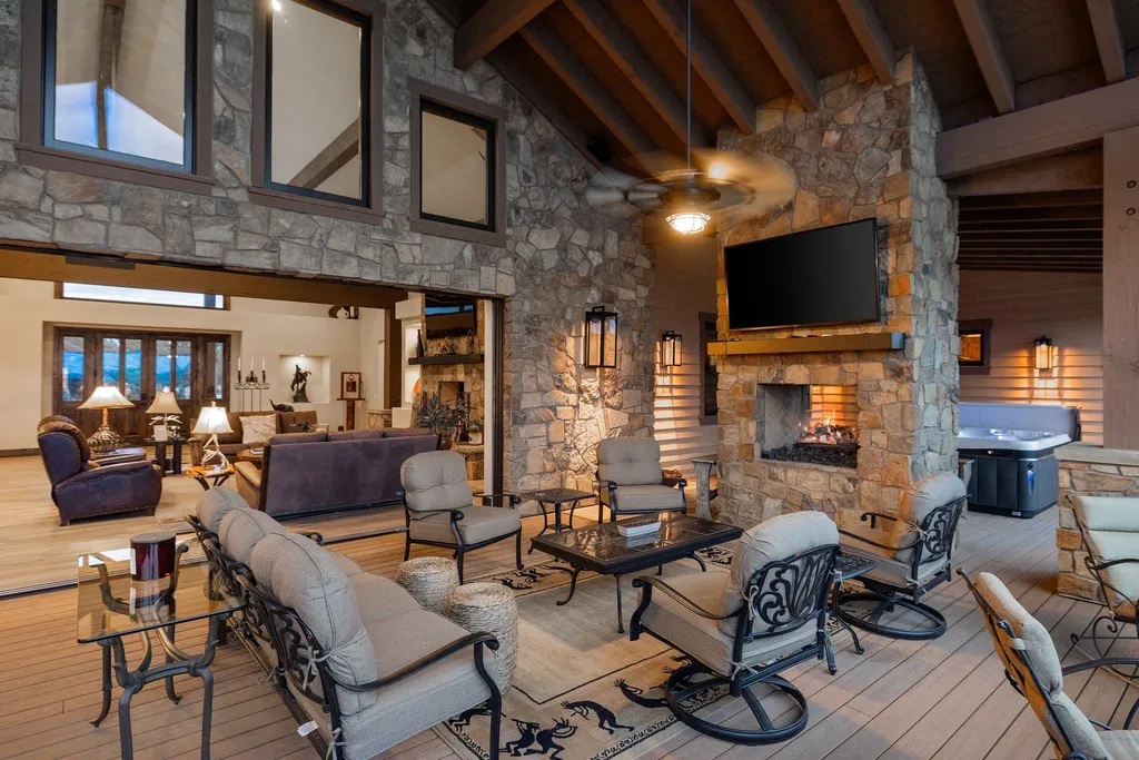 4971 West Three Forks Road Home in Prescott, Arizona. Explore the epitome of luxury living in this privately gated ranch compound with unobstructed views. This 4-bedroom, 5,555 sq.ft home features a 7-car garage, attached guest quarters, private pool with cabana, wet bar, and a 20 ft indoor-outdoor panoramic glass wall door.