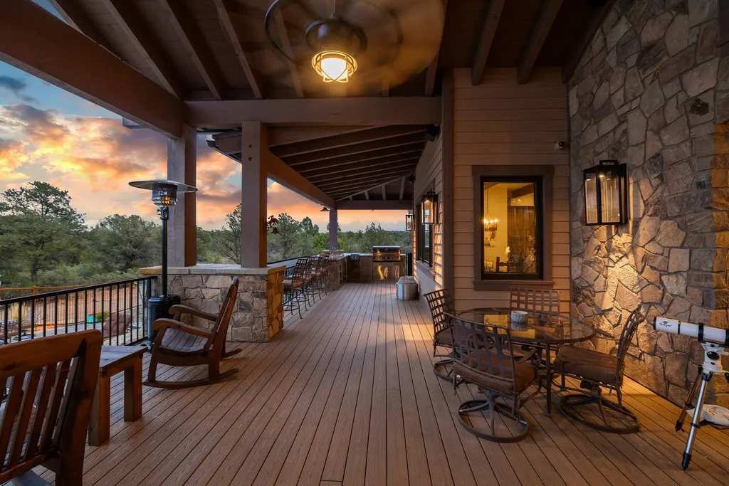 4971 West Three Forks Road Home in Prescott, Arizona. Explore the epitome of luxury living in this privately gated ranch compound with unobstructed views. This 4-bedroom, 5,555 sq.ft home features a 7-car garage, attached guest quarters, private pool with cabana, wet bar, and a 20 ft indoor-outdoor panoramic glass wall door.