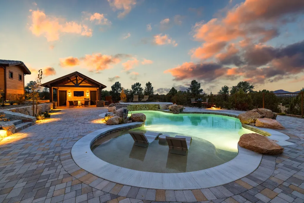 4971 West Three Forks Road Home in Prescott, Arizona. Explore the epitome of luxury living in this privately gated ranch compound with unobstructed views. This 4-bedroom, 5,555 sq.ft home features a 7-car garage, attached guest quarters, private pool with cabana, wet bar, and a 20 ft indoor-outdoor panoramic glass wall door.