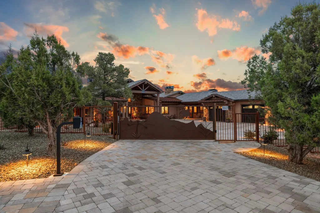 4971 West Three Forks Road Home in Prescott, Arizona. Explore the epitome of luxury living in this privately gated ranch compound with unobstructed views. This 4-bedroom, 5,555 sq.ft home features a 7-car garage, attached guest quarters, private pool with cabana, wet bar, and a 20 ft indoor-outdoor panoramic glass wall door.