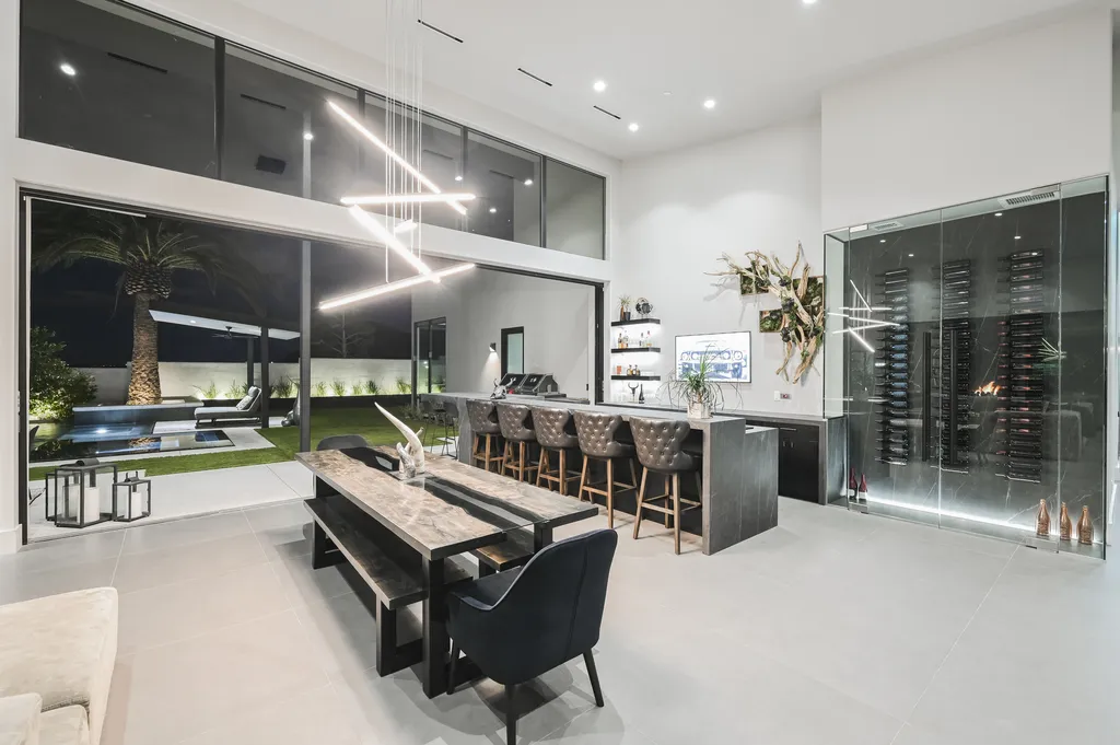 5305 Secluded Brook Court Home in Las Vegas, Nevada. Nestled within the exclusive Serenity Brook Estates at Lone Mountain, this contemporary masterpiece is a true testament to modern luxury living. Situated on a generous half-acre lot, this home offers a seamless fusion of indoor and outdoor spaces.