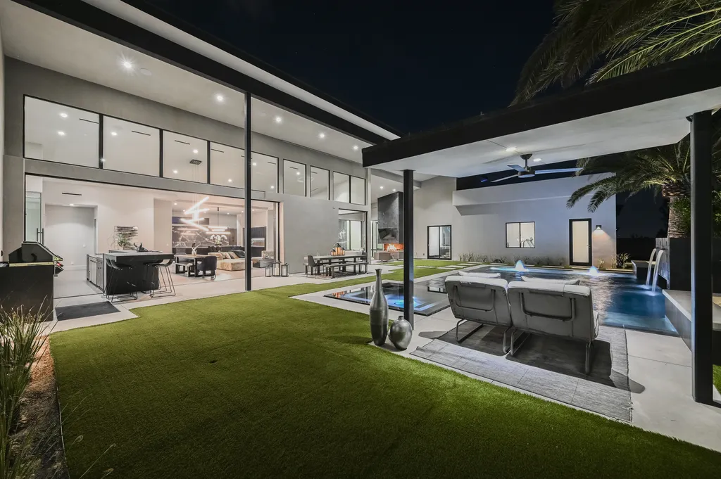 5305 Secluded Brook Court Home in Las Vegas, Nevada. Nestled within the exclusive Serenity Brook Estates at Lone Mountain, this contemporary masterpiece is a true testament to modern luxury living. Situated on a generous half-acre lot, this home offers a seamless fusion of indoor and outdoor spaces.