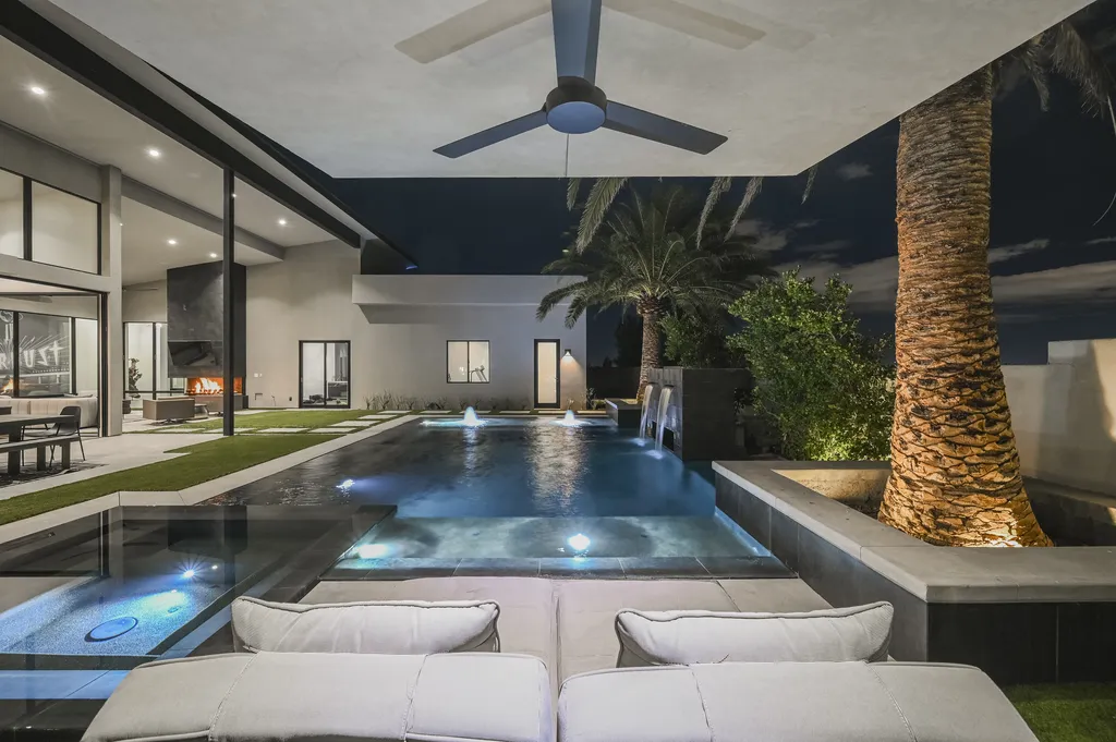 5305 Secluded Brook Court Home in Las Vegas, Nevada. Nestled within the exclusive Serenity Brook Estates at Lone Mountain, this contemporary masterpiece is a true testament to modern luxury living. Situated on a generous half-acre lot, this home offers a seamless fusion of indoor and outdoor spaces.