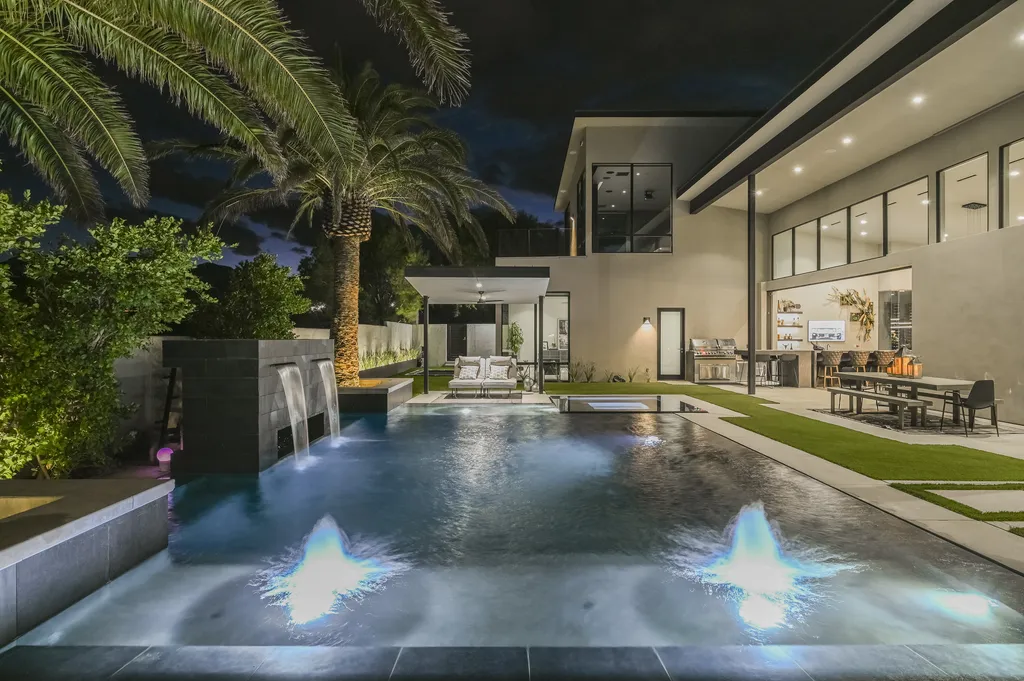 5305 Secluded Brook Court Home in Las Vegas, Nevada. Nestled within the exclusive Serenity Brook Estates at Lone Mountain, this contemporary masterpiece is a true testament to modern luxury living. Situated on a generous half-acre lot, this home offers a seamless fusion of indoor and outdoor spaces.