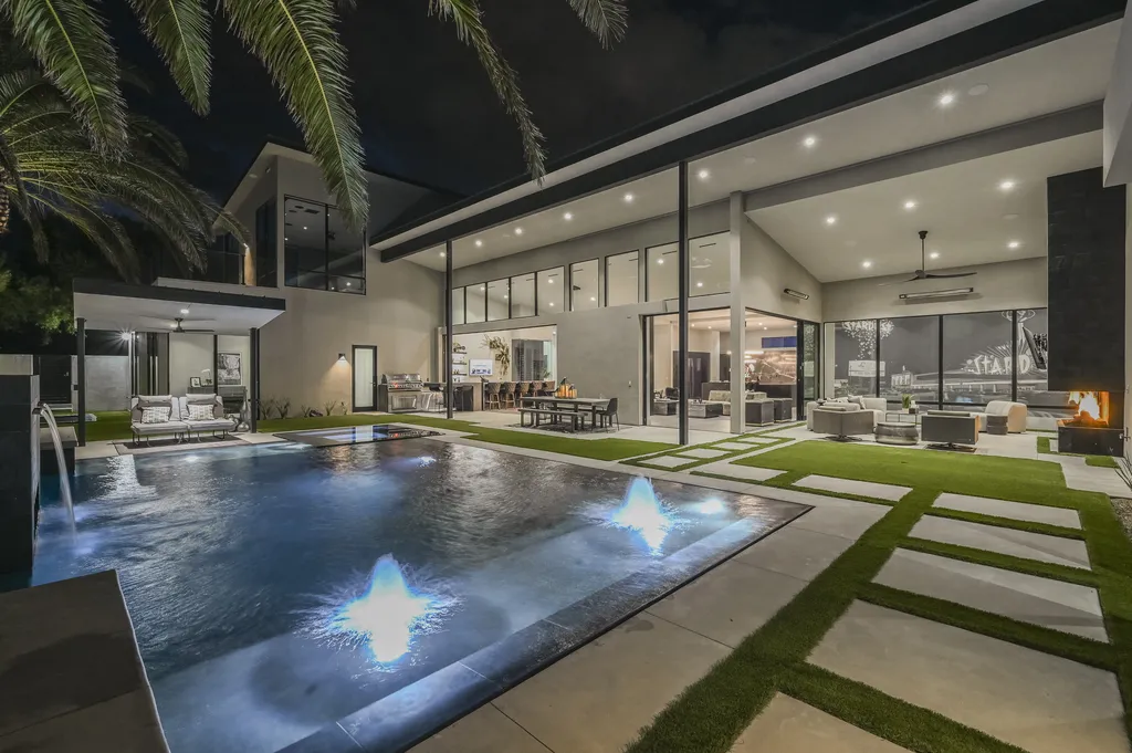 5305 Secluded Brook Court Home in Las Vegas, Nevada. Nestled within the exclusive Serenity Brook Estates at Lone Mountain, this contemporary masterpiece is a true testament to modern luxury living. Situated on a generous half-acre lot, this home offers a seamless fusion of indoor and outdoor spaces.