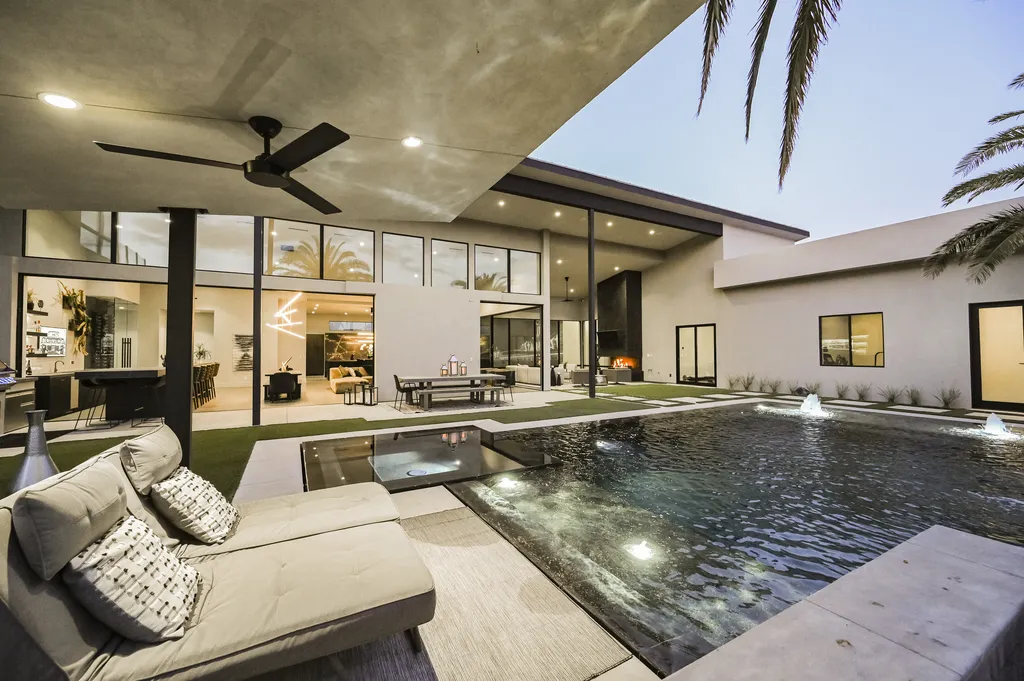 5305 Secluded Brook Court Home in Las Vegas, Nevada. Nestled within the exclusive Serenity Brook Estates at Lone Mountain, this contemporary masterpiece is a true testament to modern luxury living. Situated on a generous half-acre lot, this home offers a seamless fusion of indoor and outdoor spaces.