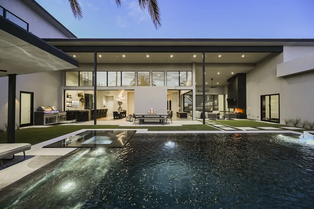 5305 Secluded Brook Court Home in Las Vegas, Nevada. Nestled within the exclusive Serenity Brook Estates at Lone Mountain, this contemporary masterpiece is a true testament to modern luxury living. Situated on a generous half-acre lot, this home offers a seamless fusion of indoor and outdoor spaces.