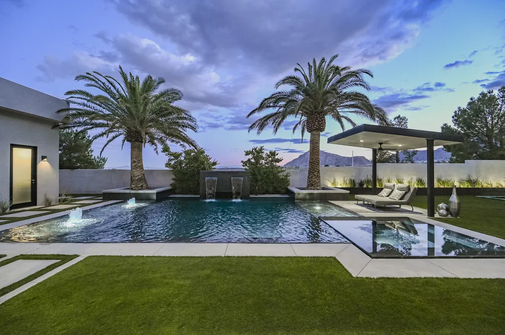 5305 Secluded Brook Court Home in Las Vegas, Nevada. Nestled within the exclusive Serenity Brook Estates at Lone Mountain, this contemporary masterpiece is a true testament to modern luxury living. Situated on a generous half-acre lot, this home offers a seamless fusion of indoor and outdoor spaces.