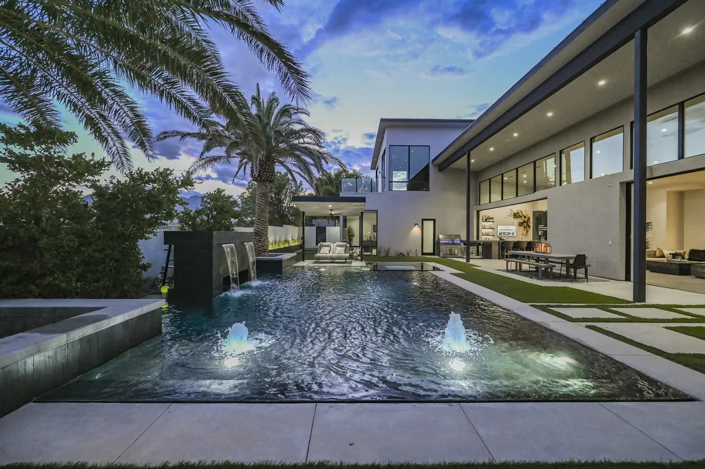 5305 Secluded Brook Court Home in Las Vegas, Nevada. Nestled within the exclusive Serenity Brook Estates at Lone Mountain, this contemporary masterpiece is a true testament to modern luxury living. Situated on a generous half-acre lot, this home offers a seamless fusion of indoor and outdoor spaces.