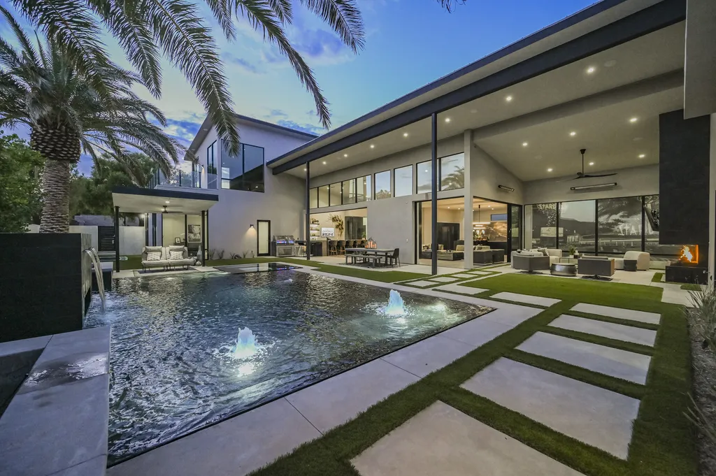5305 Secluded Brook Court Home in Las Vegas, Nevada. Nestled within the exclusive Serenity Brook Estates at Lone Mountain, this contemporary masterpiece is a true testament to modern luxury living. Situated on a generous half-acre lot, this home offers a seamless fusion of indoor and outdoor spaces.