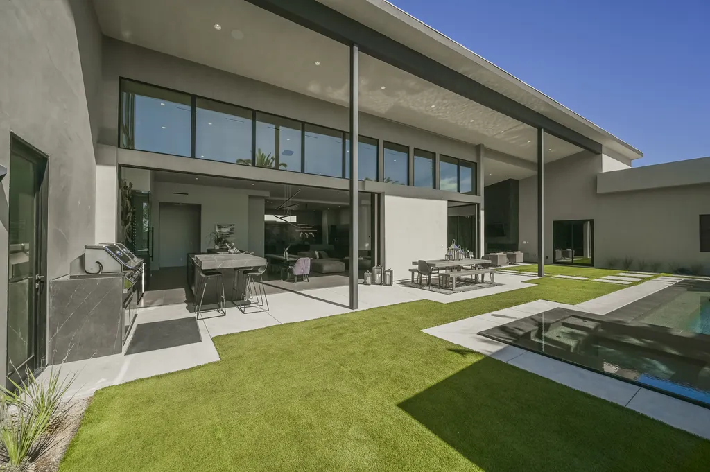 5305 Secluded Brook Court Home in Las Vegas, Nevada. Nestled within the exclusive Serenity Brook Estates at Lone Mountain, this contemporary masterpiece is a true testament to modern luxury living. Situated on a generous half-acre lot, this home offers a seamless fusion of indoor and outdoor spaces.