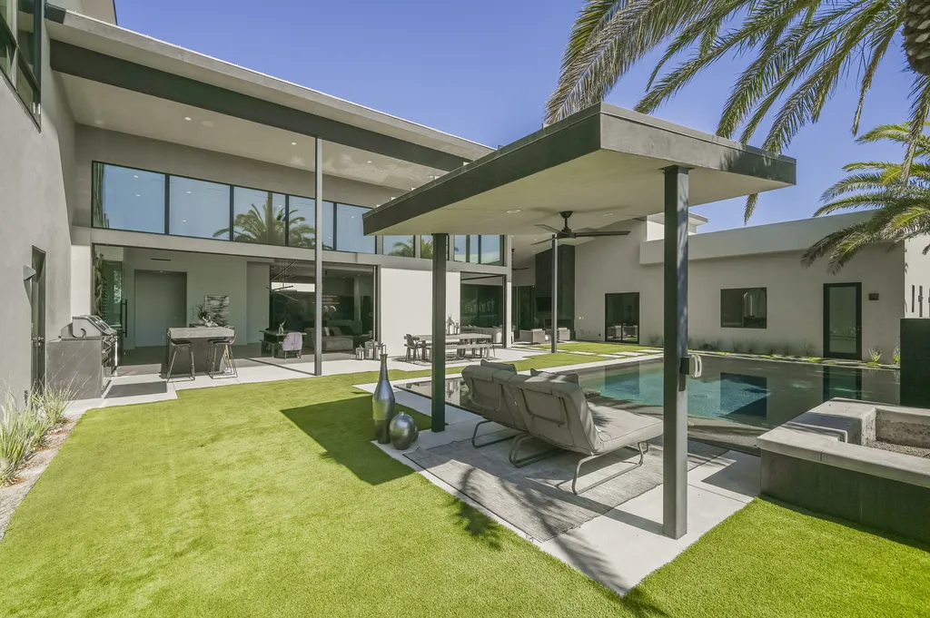 5305 Secluded Brook Court Home in Las Vegas, Nevada. Nestled within the exclusive Serenity Brook Estates at Lone Mountain, this contemporary masterpiece is a true testament to modern luxury living. Situated on a generous half-acre lot, this home offers a seamless fusion of indoor and outdoor spaces.