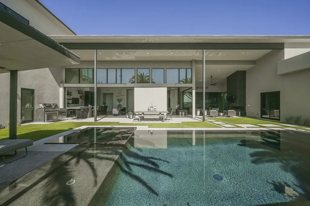 5305 Secluded Brook Court Home in Las Vegas, Nevada. Nestled within the exclusive Serenity Brook Estates at Lone Mountain, this contemporary masterpiece is a true testament to modern luxury living. Situated on a generous half-acre lot, this home offers a seamless fusion of indoor and outdoor spaces.