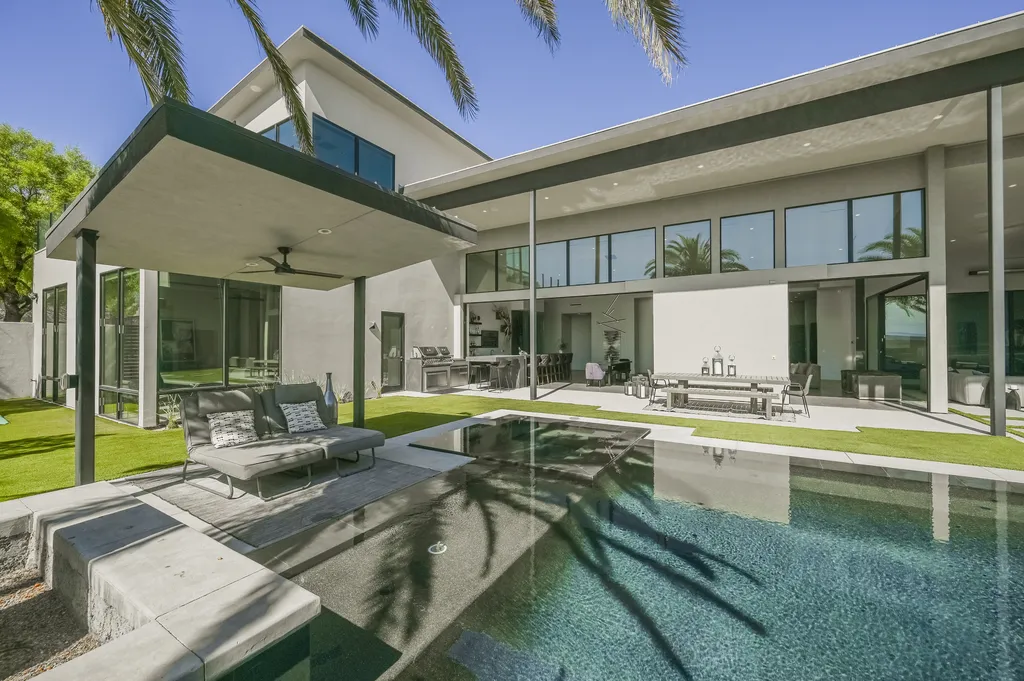 5305 Secluded Brook Court Home in Las Vegas, Nevada. Nestled within the exclusive Serenity Brook Estates at Lone Mountain, this contemporary masterpiece is a true testament to modern luxury living. Situated on a generous half-acre lot, this home offers a seamless fusion of indoor and outdoor spaces.