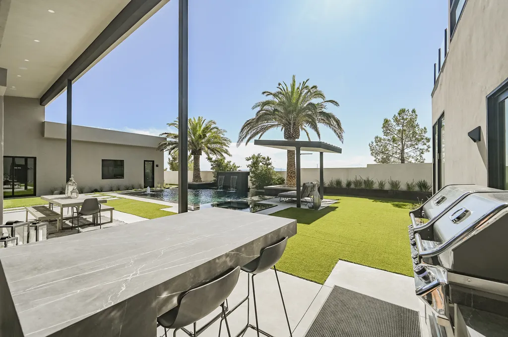 5305 Secluded Brook Court Home in Las Vegas, Nevada. Nestled within the exclusive Serenity Brook Estates at Lone Mountain, this contemporary masterpiece is a true testament to modern luxury living. Situated on a generous half-acre lot, this home offers a seamless fusion of indoor and outdoor spaces.