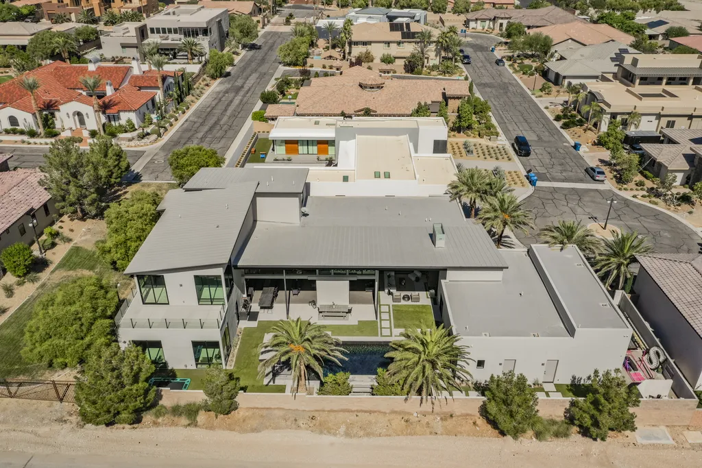 5305 Secluded Brook Court Home in Las Vegas, Nevada. Nestled within the exclusive Serenity Brook Estates at Lone Mountain, this contemporary masterpiece is a true testament to modern luxury living. Situated on a generous half-acre lot, this home offers a seamless fusion of indoor and outdoor spaces.