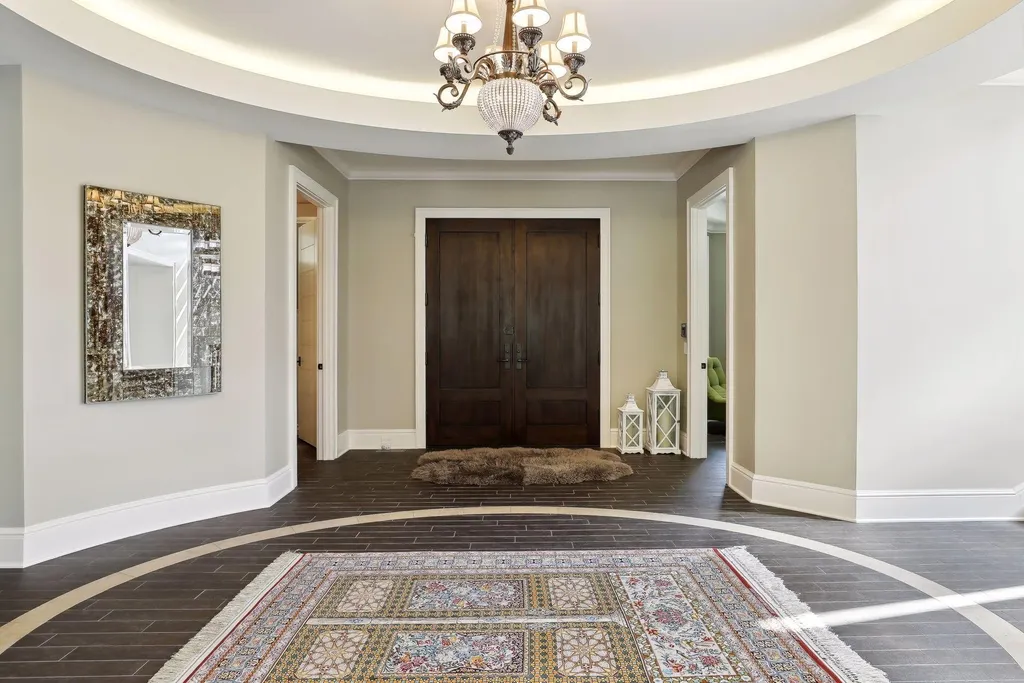 5790 Jasmine Lane SW Home in Rochester, Minnesota. Discover unparalleled luxury in this 11,000 SF architectural masterpiece by renowned architect John McMiller. Nestled on a private lot, this smart home is a blend of elegance and technology, featuring a pool deck, theater room, and heated floors throughout.