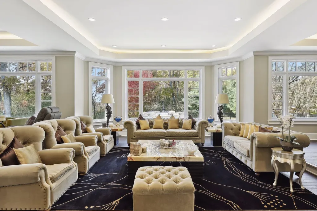 5790 Jasmine Lane SW Home in Rochester, Minnesota. Discover unparalleled luxury in this 11,000 SF architectural masterpiece by renowned architect John McMiller. Nestled on a private lot, this smart home is a blend of elegance and technology, featuring a pool deck, theater room, and heated floors throughout.